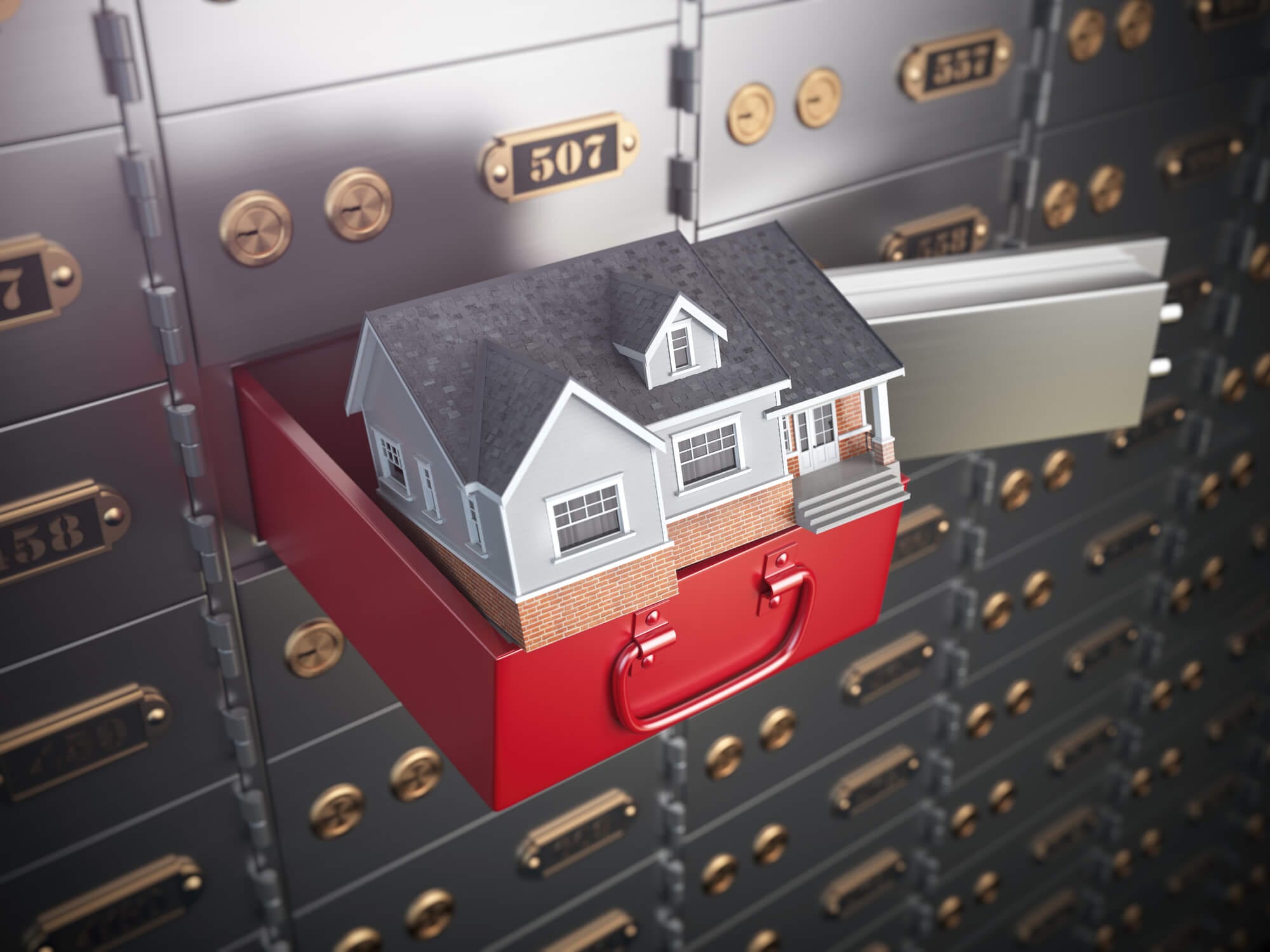 Symbolic photo of a house in a safety deposit box. 